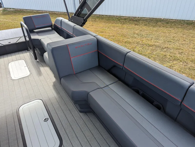 Slide: The Image of 2024 Manitou Explore 22 MAX w/150 Rotax interior seating, gray upholstery with red stitching. - 9