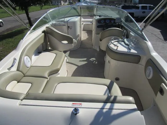 Slide: The Image of 2005 Sea Ray 270 Sundeck interior with beige seating and dashboard. - 12
