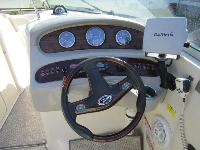 Slide: The Image of 2005 Sea Ray 270 Sundeck helm with Garmin GPS and wood-accented dashboard. - 13