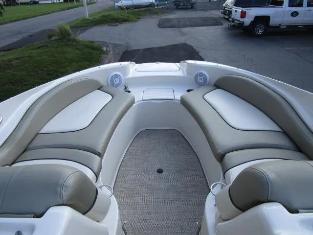 Slide: The Image of 2005 Sea Ray 270 Sundeck boat interior with cushioned seating and carpeted floor. - 16