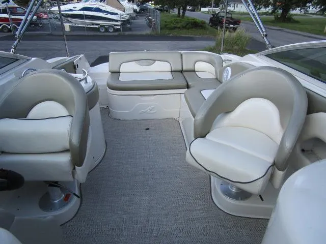 Slide: The Image of 2005 Sea Ray 270 Sundeck interior with cushioned seating and helm chairs. - 17