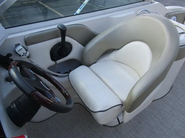 Slide: The Image of 2005 Sea Ray 270 Sundeck helm with steering wheel and captain's chair. - 18