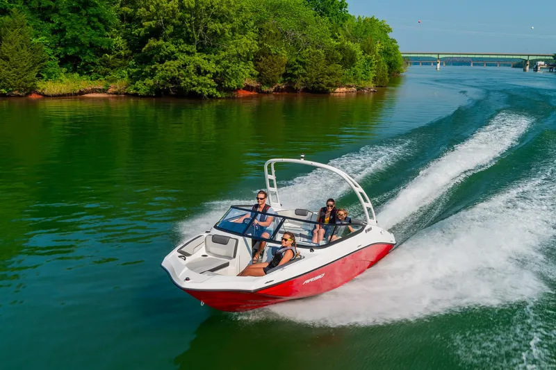 Slide: The Image of 2024 Yamaha Boats AR190 speeding on a lake with passengers. - 10