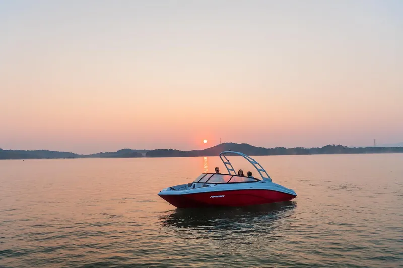 Slide: The Image of 2024 Yamaha Boats AR190 on a serene lake at sunset. - 9