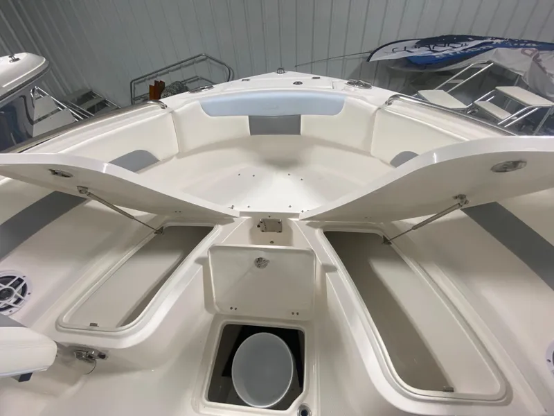 Slide: The Image of 2024 Robalo R222 Center Console boat with open storage compartments. - 19