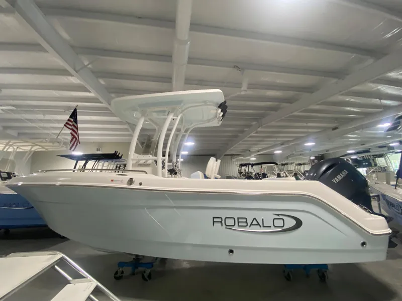 Slide: The Image of 2024 Robalo R222 Center Console boat in showroom. - 2