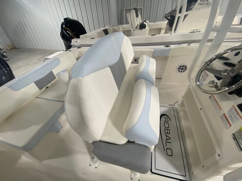Slide: The Image of 2024 Robalo R222 Center Console boat interior with white and gray seating. - 10