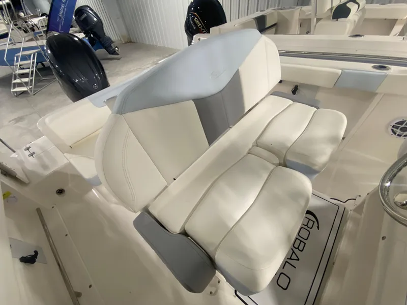 Slide: The Image of 2024 Robalo R222 Center Console boat seating area with cushioned seats. - 11