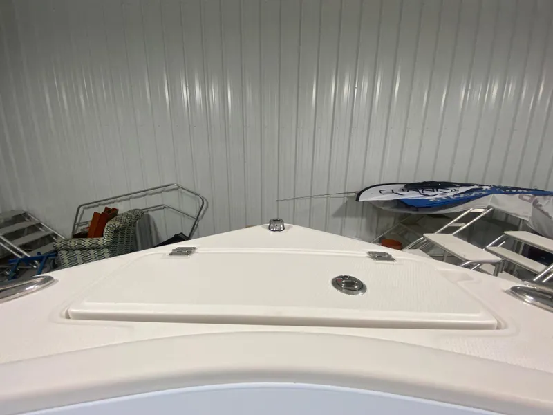 Slide: The Image of 2024 Robalo R222 Center Console boat bow in storage facility. - 22