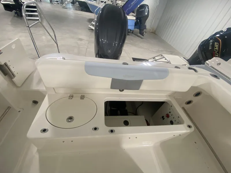 Slide: The Image of 2024 Robalo R222 Center Console boat interior with storage compartments and seating. - 6