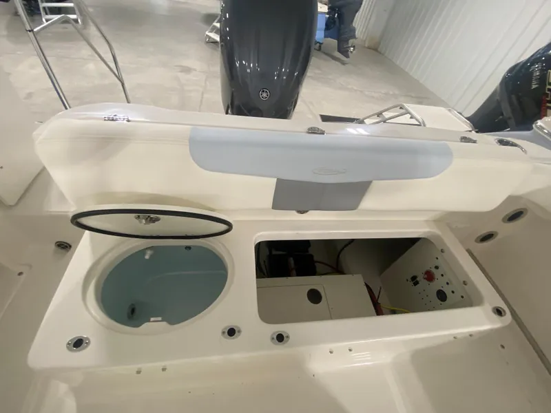 Slide: The Image of 2024 Robalo R222 Center Console boat interior with storage compartments and livewell. - 7