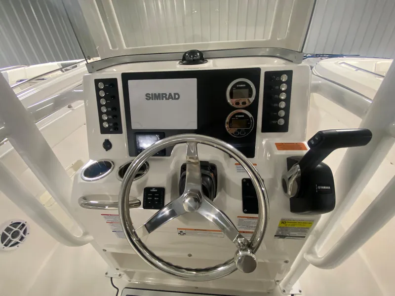 Slide: The Image of 2024 Robalo R222 Center Console boat helm with Simrad electronics. - 9
