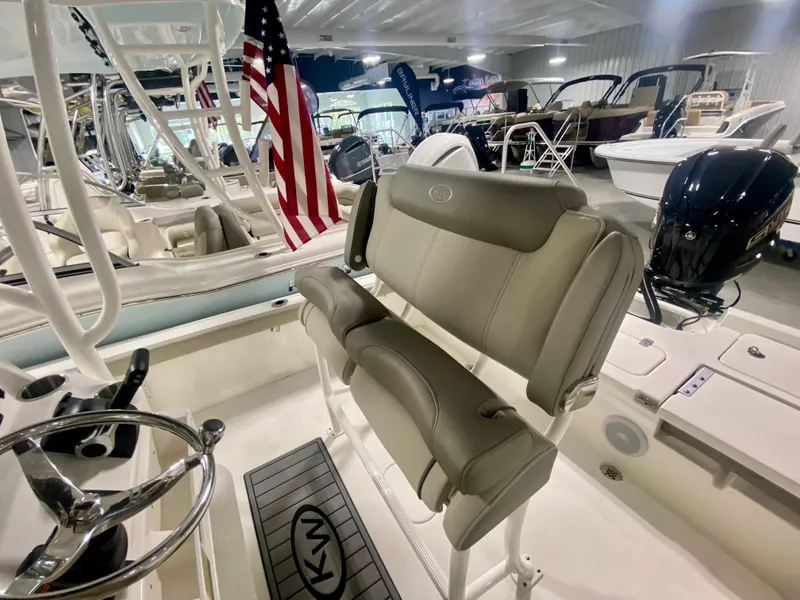 Slide: The Image of 2024 Key West 230 Bay Reef boat interior with seating and steering wheel. - 12