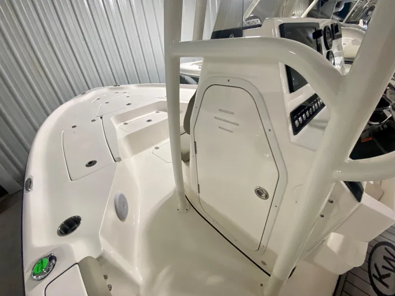 Slide: The Image of 2024 Key West 230 Bay Reef boat interior, featuring console and storage compartments. - 16