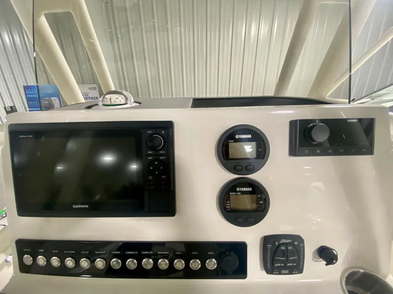 Slide: The Image of 2024 Key West 230 Bay Reef boat dashboard with Garmin and Yamaha controls. - 21