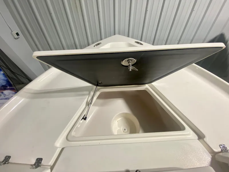 Slide: The Image of 2024 Key West 230 Bay Reef boat storage compartment with open hatch. - 24