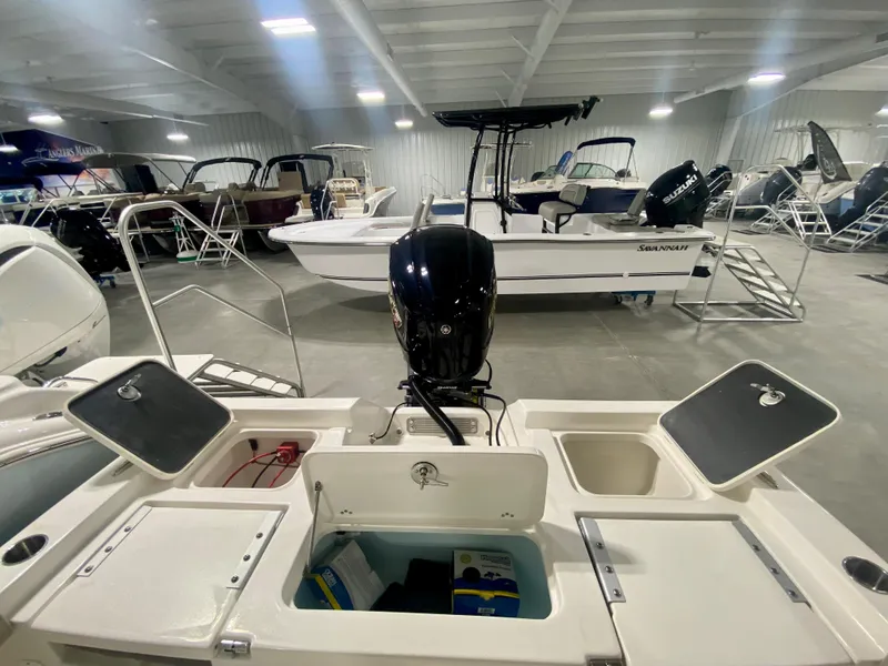 Slide: The Image of 2024 Key West 230 Bay Reef boat in showroom, rear view with open compartments. - 7
