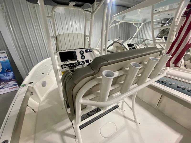 Slide: The Image of 2024 Key West 230 Bay Reef boat interior with console and rod holders. - 11