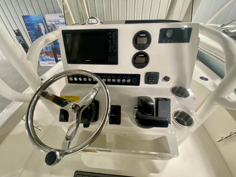 Slide: The Image of 2024 Key West 230 Bay Reef boat console with steering wheel and navigation controls. - 14
