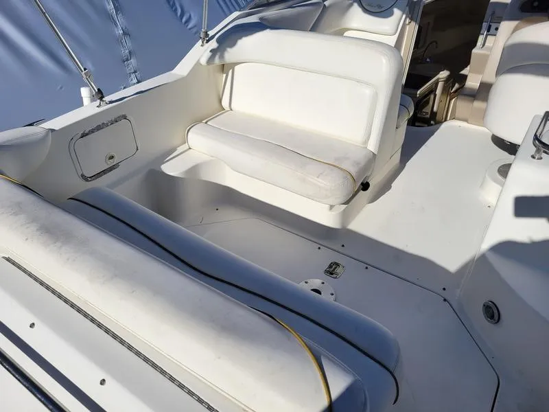 Slide: The Image of 2001 Sea Ray 26' Sundancer boat interior with white seating and clean deck. - 12