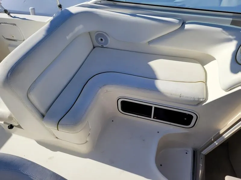 Slide: The Image of 2001 Sea Ray 26' Sundancer boat interior with white cushioned seating. - 15