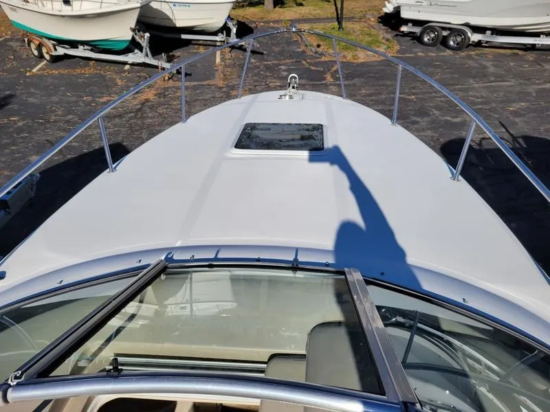 Slide: The Image of 2001 Sea Ray 26' Sundancer boat deck with railing and hatch, parked on a trailer. - 17