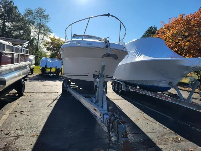 Slide: The Image of 2001 Sea Ray 26' Sundancer boat on trailer, parked outdoors in sunny weather. - 2