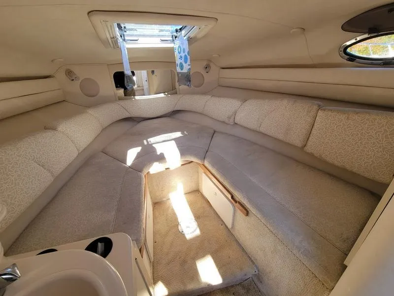 Slide: The Image of Interior of 2001 Sea Ray 26' Sundancer cabin with beige seating and skylight. - 20