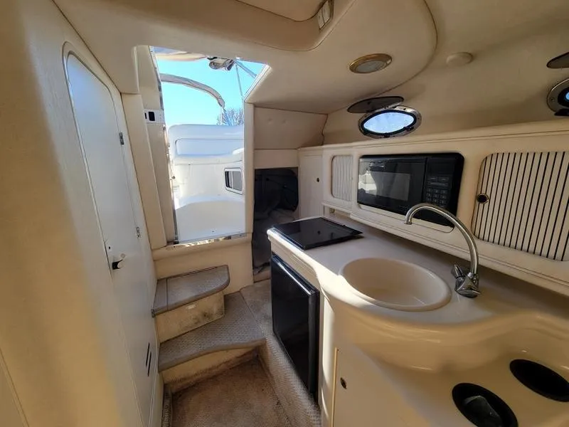 Slide: The Image of Interior of 2001 Sea Ray 26' Sundancer boat with kitchenette and stairs. - 21