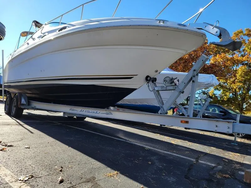 Slide: The Image of 2001 Sea Ray 26' Sundancer boat on trailer in sunny parking lot. - 4