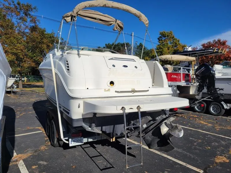 Slide: The Image of 2001 Sea Ray 26' Sundancer boat on trailer in parking lot. - 8