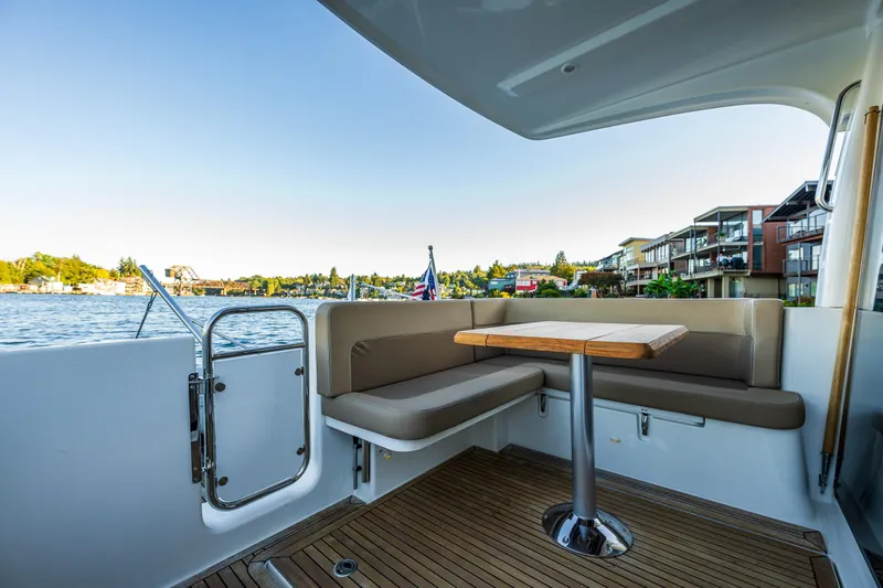 Slide: The Image of Outdoor seating area on a 2016 Nimbus 305 Coupe` boat with waterfront view. - 18