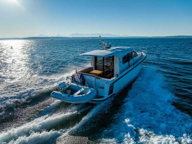 Slide: The Image of Nimbus 305 Coupe` 2016 cruising on open water with scenic mountain backdrop. - 22
