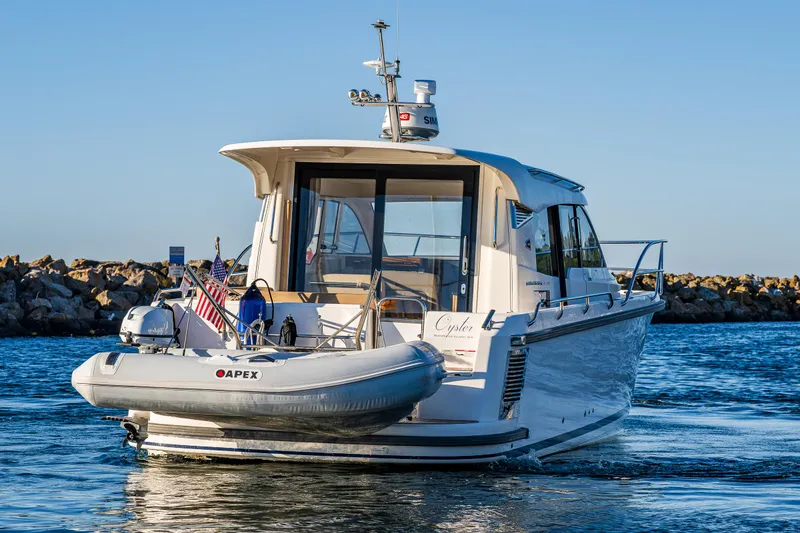 Slide: The Image of 2016 Nimbus 305 Coupe` boat with Apex dinghy on water. - 6