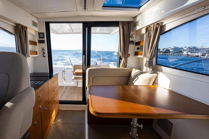 Slide: The Image of Interior of 2016 Nimbus 305 Coupe` yacht with ocean view through large windows. - 7