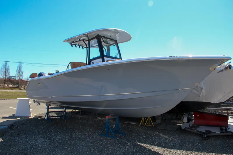Slide: The Image of 2021 Sea Hunt Ultra 275 SE boat on stands in a yard. - 0