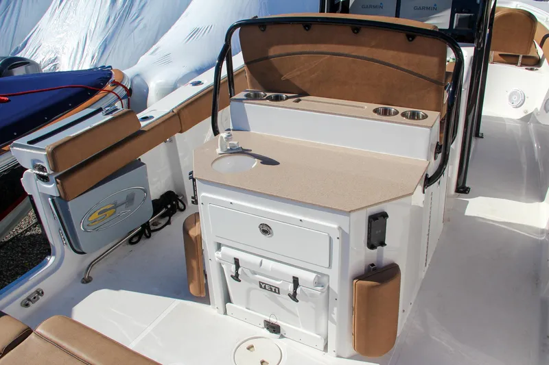 Slide: The Image of 2021 Sea Hunt Ultra 275 SE boat interior with seating and storage. - 16