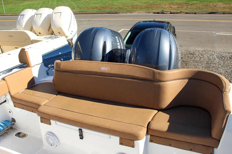 Slide: The Image of 2021 Sea Hunt Ultra 275 SE boat with twin outboard engines and tan seating. - 17