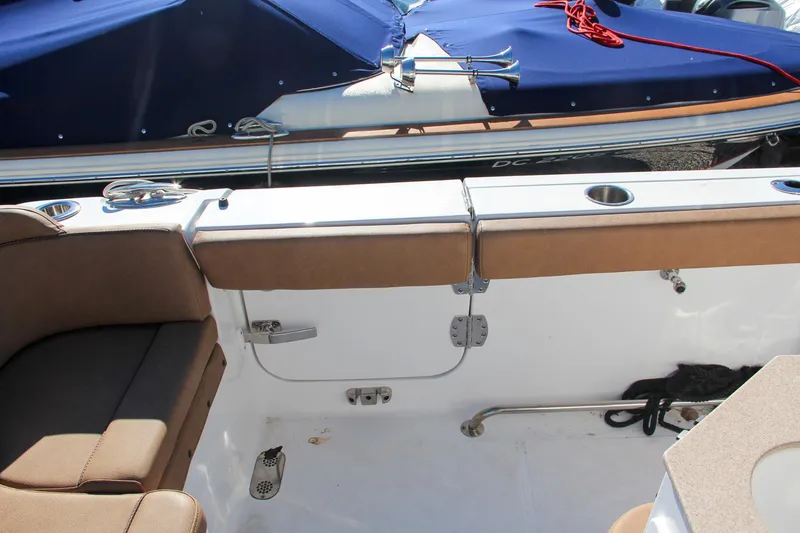 Slide: The Image of 2021 Sea Hunt Ultra 275 SE boat interior with cushioned seating and storage compartments. - 23