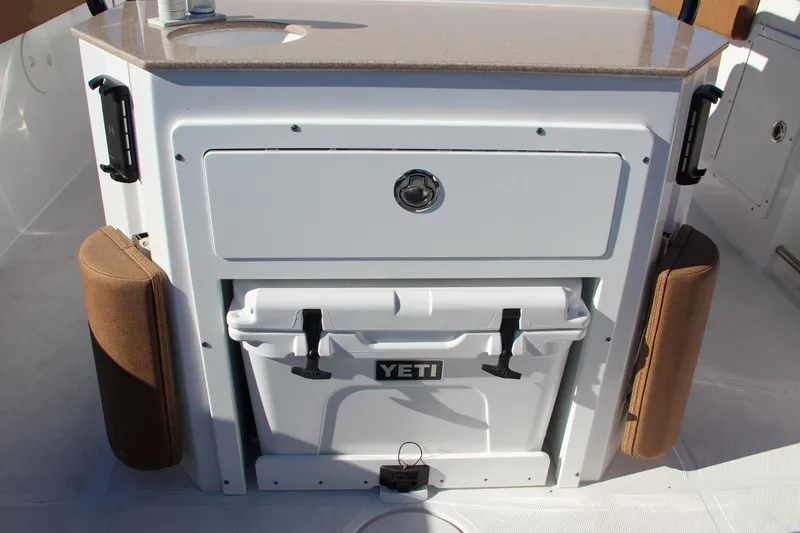 Slide: The Image of 2021 Sea Hunt Ultra 275 SE boat with Yeti cooler and storage compartment. - 26