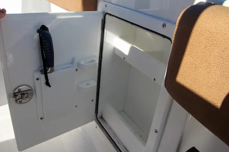 Slide: The Image of Open storage compartment on a 2021 Sea Hunt Ultra 275 SE boat. - 37