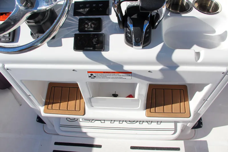 Slide: The Image of 2021 Sea Hunt Ultra 275 SE helm station with controls and storage. - 45