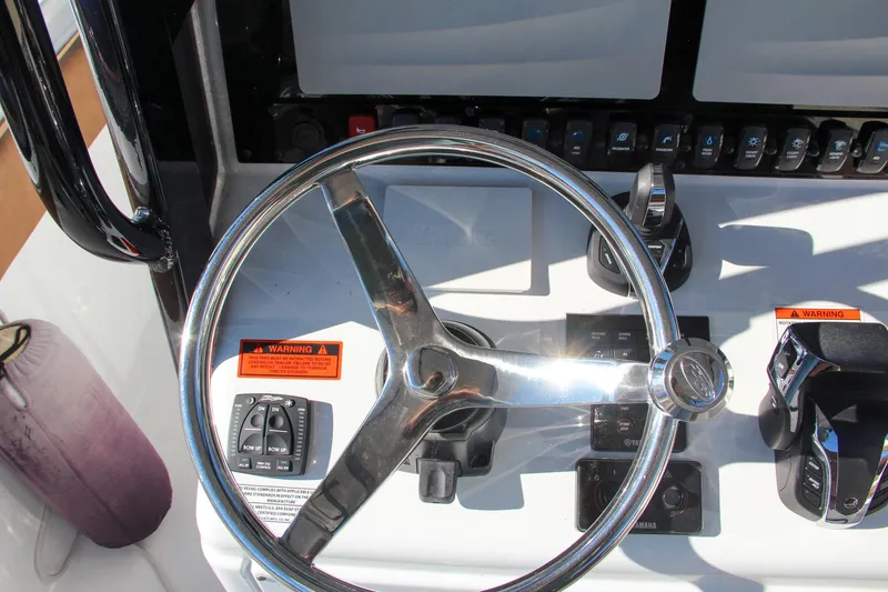 Slide: The Image of 2021 Sea Hunt Ultra 275 SE boat steering wheel and control panel. - 46