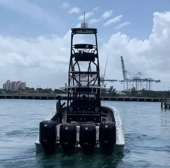 Slide: The Image of 2014 Hydra-Sports Siesta boat with four outboard engines in a harbor. - 10