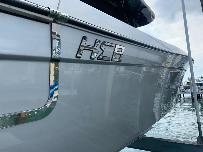 Slide: The Image of 2014 Hydra-Sports Siesta boat docked at marina, close-up of HCB logo. - 12
