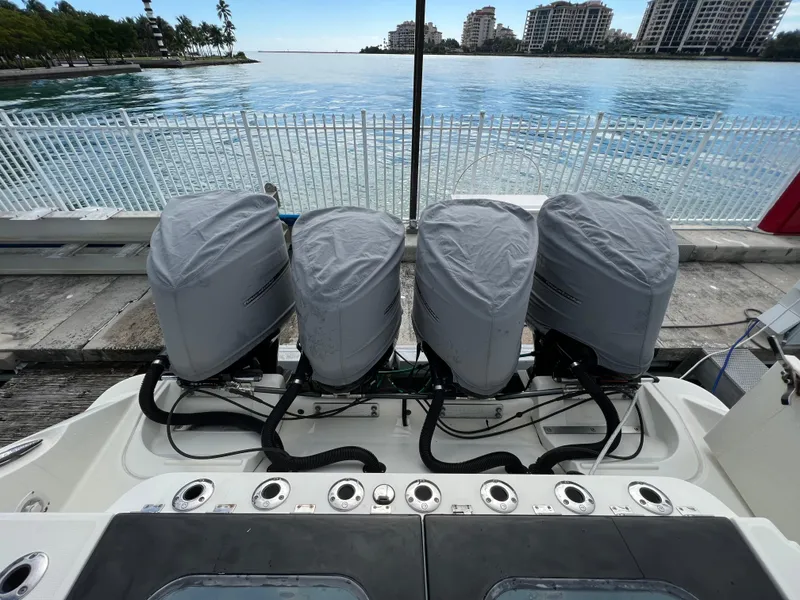 Slide: The Image of 2014 Hydra-Sports Siesta boat with four covered outboard motors docked by the water. - 5