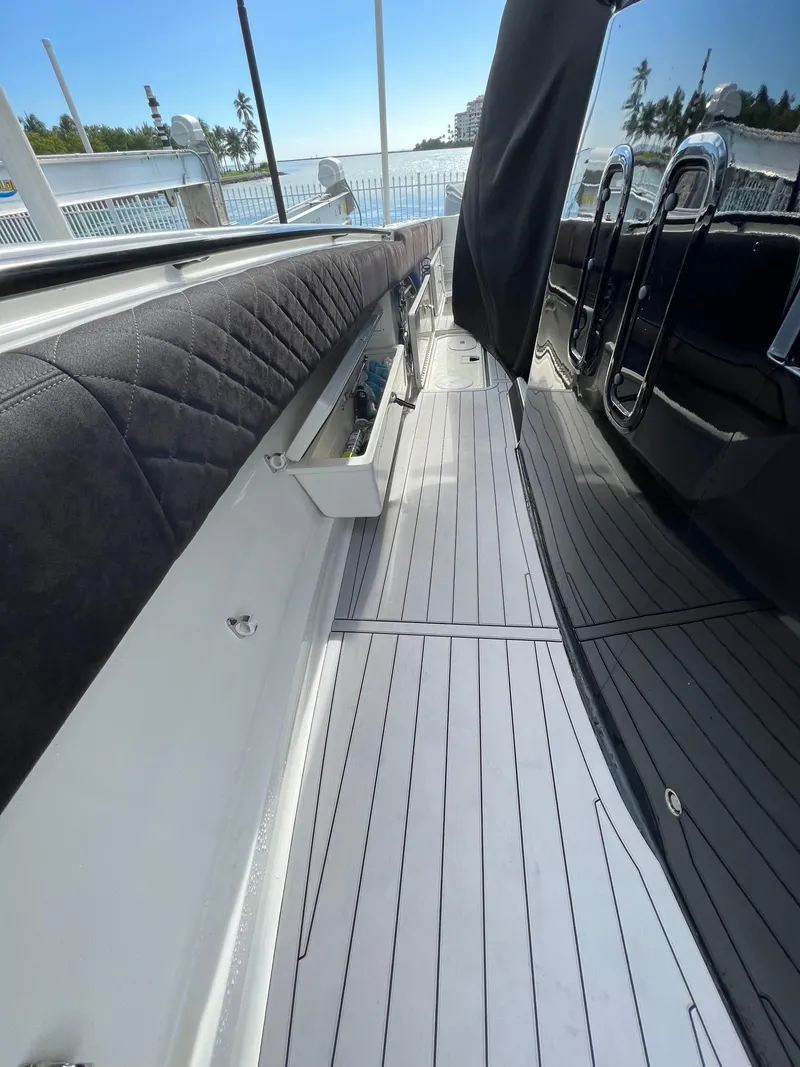 Slide: The Image of 2014 Hydra-Sports Siesta boat interior with sleek seating and storage compartments. - 6