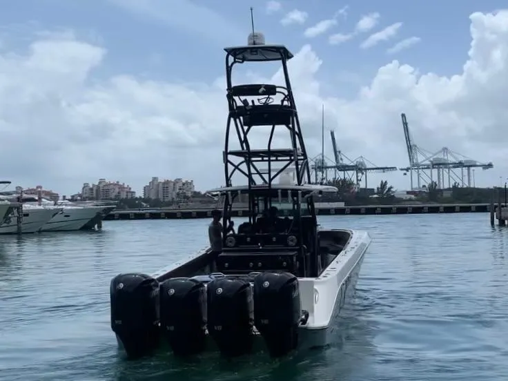 Slide: The Image of 2014 Hydra-Sports Siesta boat with quad outboard engines in a marina. - 9