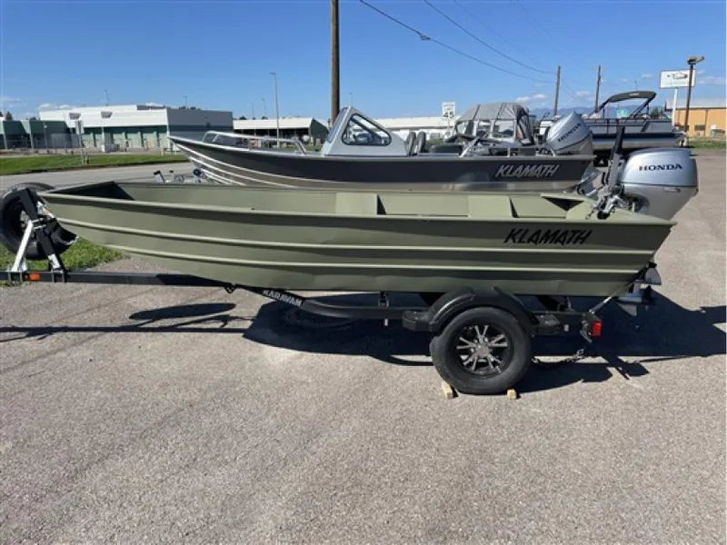 The Image of 2023 Klamath 13 Jac Wide boat on trailer, parked outdoors. - 1