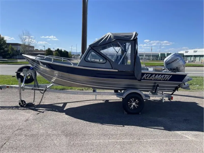 The Image of 2023 Klamath 16 Explorer Windshield boat on trailer with Honda outboard motor. - 0